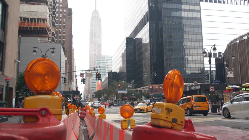 New York City, United States - 29 Aug 2023: Manhattan Midtown 34 street, 8 avenue crossroad intersection. Urban road car traffic in USA. People pedestrians on zebra. Yellow taxi, Empire State building
