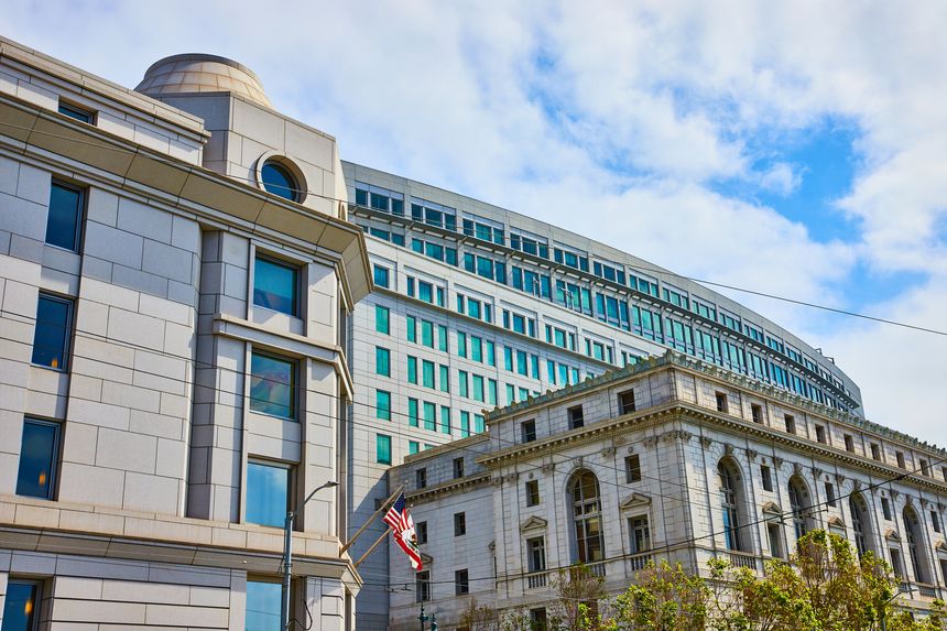 Image of Supreme Court of California and other state buildings with flags waving in wind