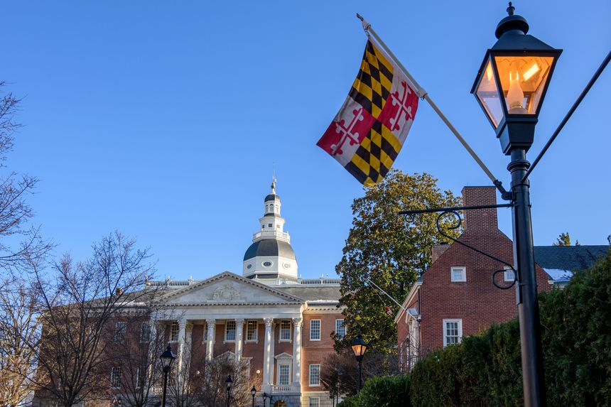 View of the State House of Maryland in Annapolis from Lawyer's Mall. The Maryland state flag hangs from a lamp post in the foreground.