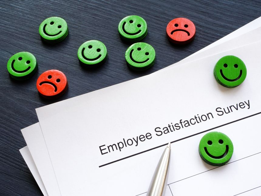 Emoticons and papers with employee satisfaction survey.