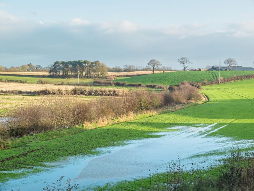 Water logged lower fields of typical Scottish farmlands in winter that need to be drained prior to spring.