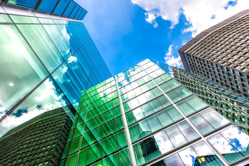 London, UK looking up on blue sky cityscape skyline exterior of office financial bank buildings in center of city in Victoria Westminster with modern glass architecture nobody low angle view