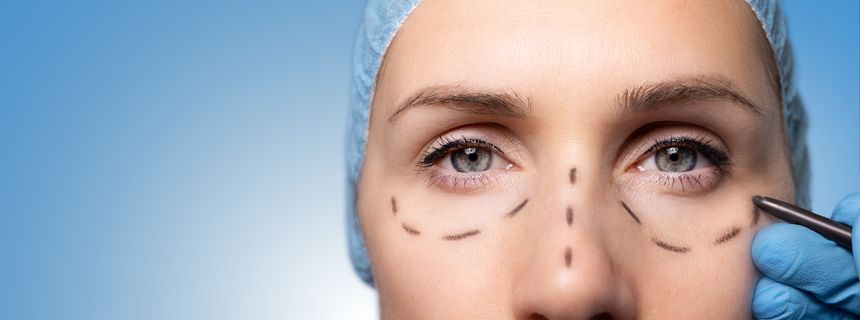 surgeon marking woman's face for cosmetic plastic surgery. facelift procedure. banner with copy space