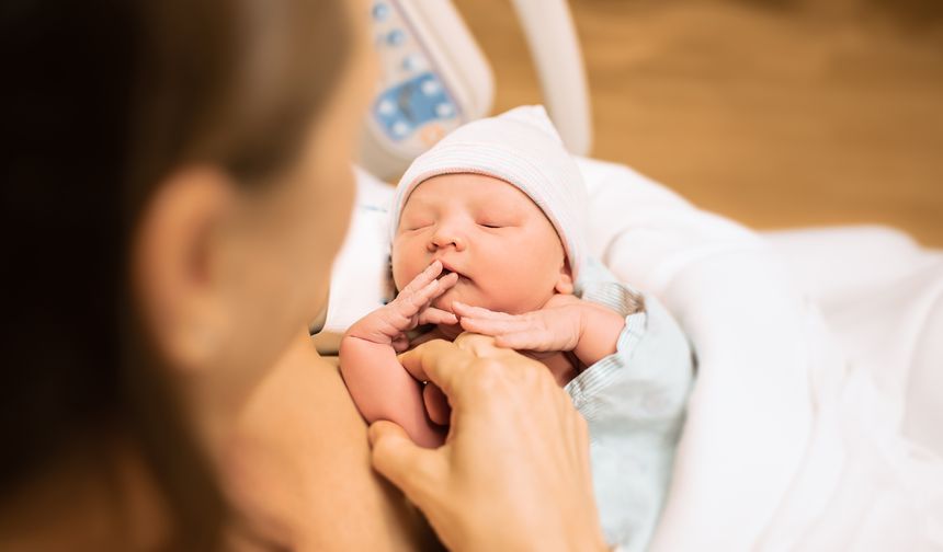 New born baby in hospital bed, child birth, and new life concept.