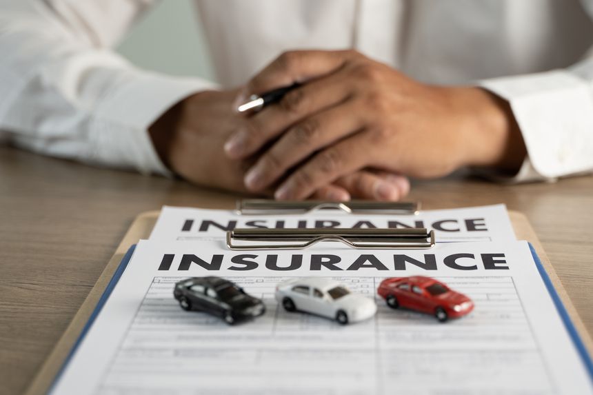 Concept of insurance man protective and car family health insurance policy examining