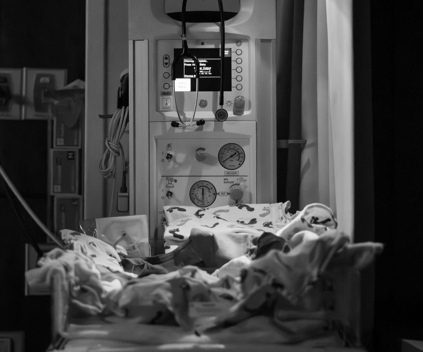 Baby Warming Machine in Hospital Birthing Room Prepped with Blankets and Lights for After Baby is Born