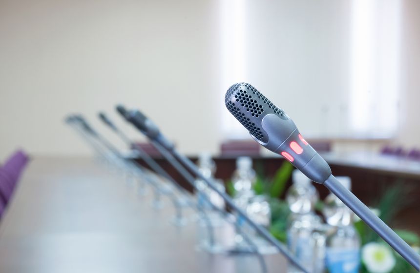 close up of a microphone in empty conference hall