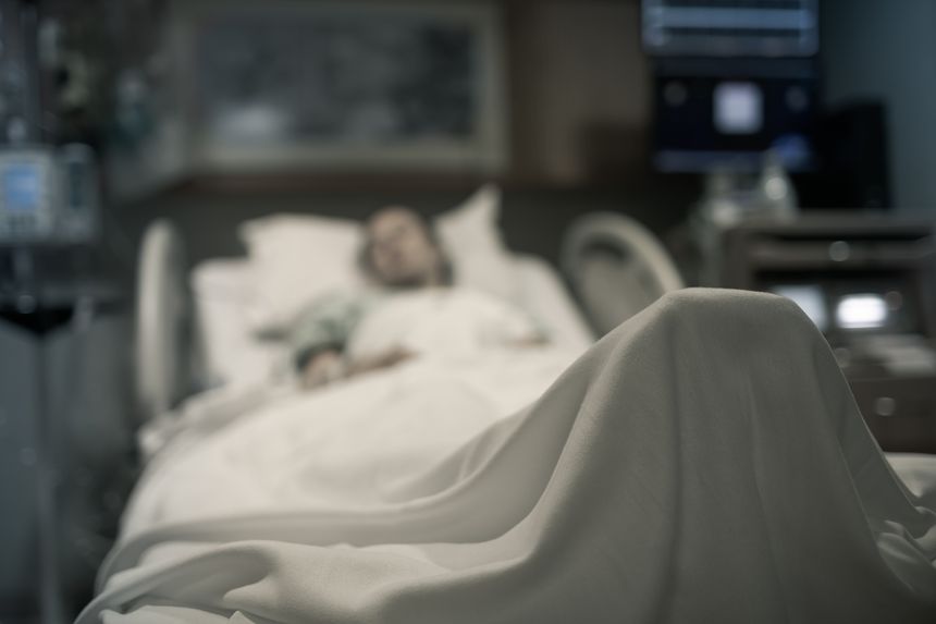 Sick woman lying in the hospital bed.
