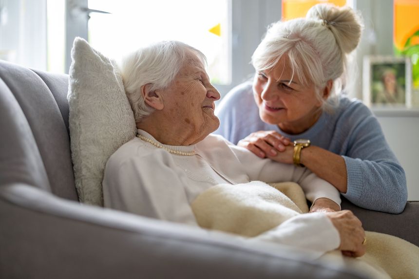 Elderly woman with her caregiver at nursing home