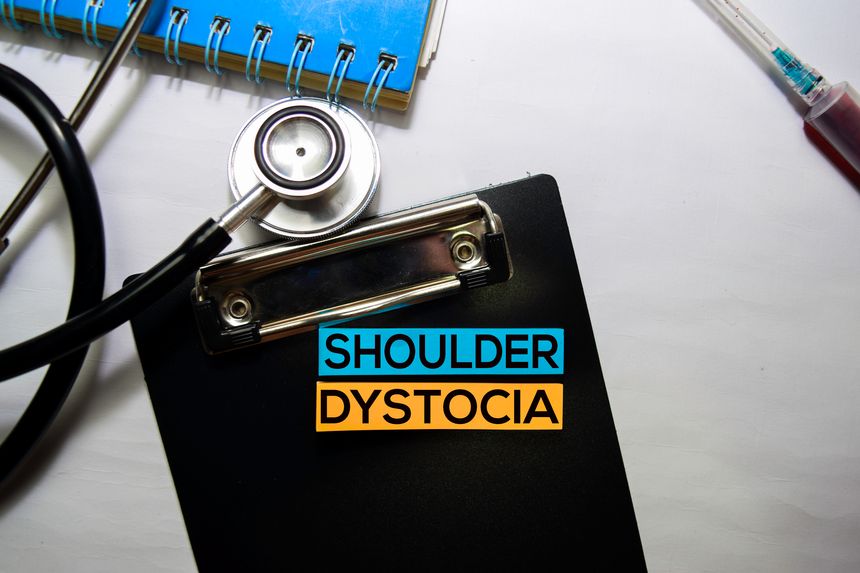 Shoulder Dystocia text on top view isolated on white background. Healthcare/Medical concept