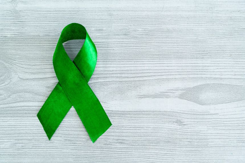 Alport Syndrome Awareness Month image, Green ribbon with copy space, World Glaucoma Day background