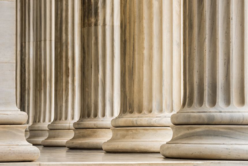 Architectural detail of Ionic order marble columns in a row
