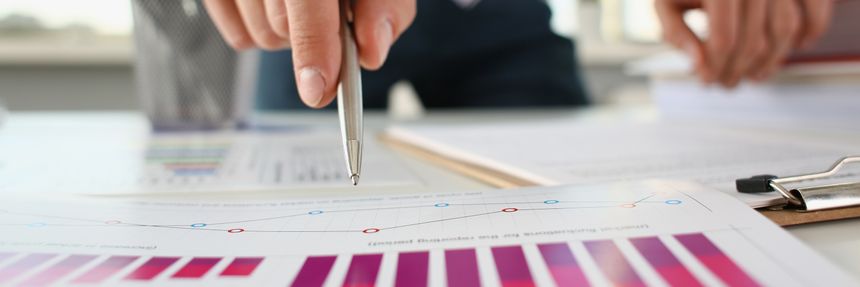 Male hands hold documents with financial statistics at office workspace closeup. White collar check money papers stock exchange market internal Revenue Service inspector earning list concept