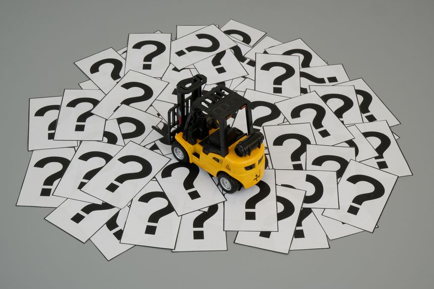 Forklift model on many question marks.  Transportation and delivery questions concept.