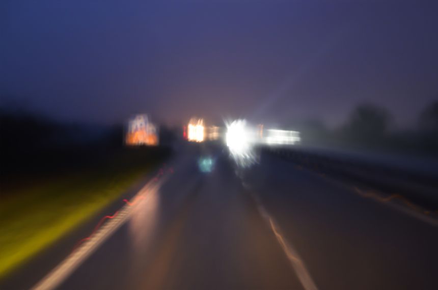 Road at night viewed   by drunk driver. Don't drink and drive