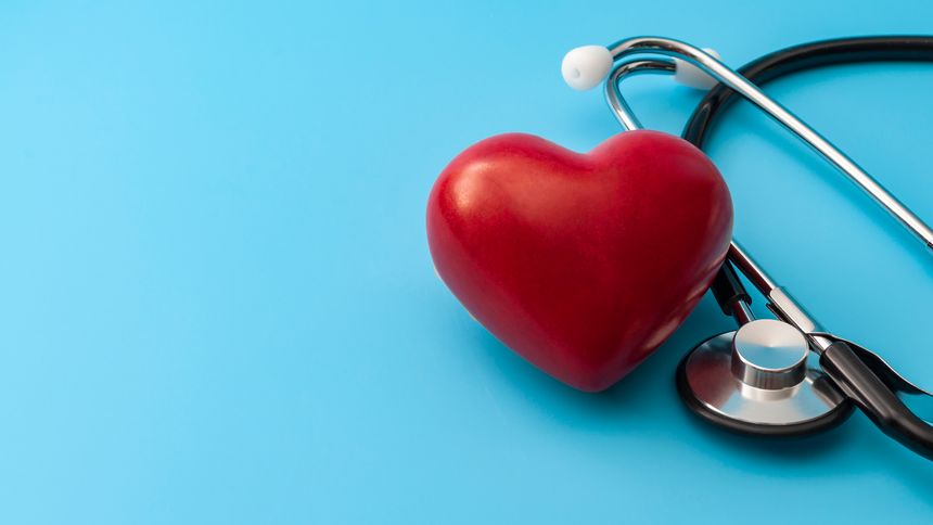 Blood pressure and heartbeat checkup, cardiac clinical exam and blood pressure test concept with red heart and stethoscope isolated on blue backgrounds with copy-space