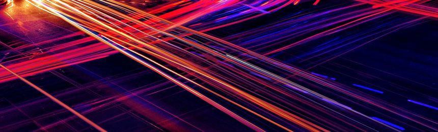 Car light trails busy night traffic traces at crossroad long exposure