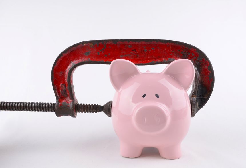 A clamp around a pink piggybank