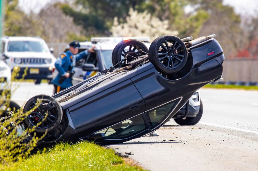 Hammonton, NJ, USA, 03/30/2024: Vehicle rollover highway road accident with police in the back