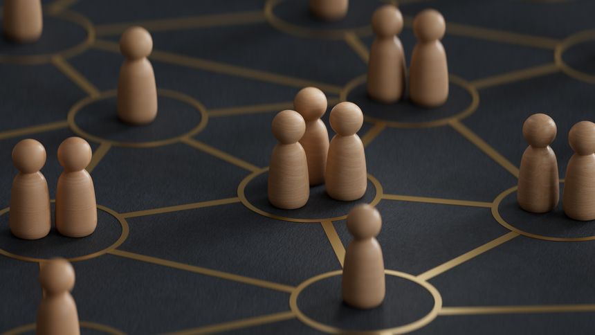 Close-up of colorful wooden pawns on interconnected circles. Concept of interrelationships. 3d illustration.3D rendering on black background.