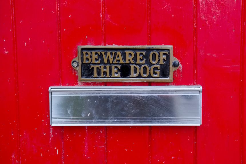 Beware of dog sign on front gate of house above letter box for safety of visitors or postman and delivery man and for home security