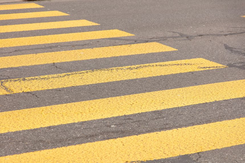 Pedestrian crossing, yellow color stripes crosswalk, closeup view