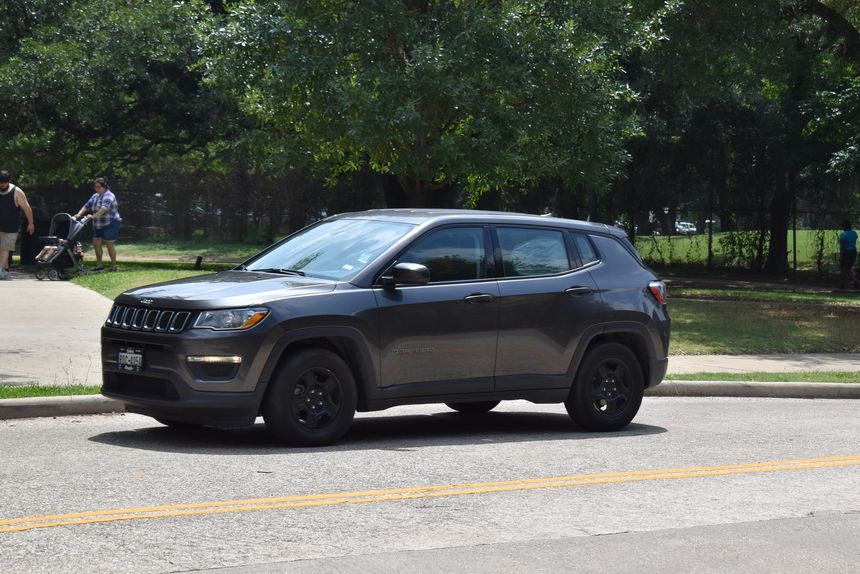 Houston, Texas USA - Hermann Park, Summer 6/06/2023 -Portrait of a Jeep Compass mid-sized SUV cruising through Hermann Park in Houston