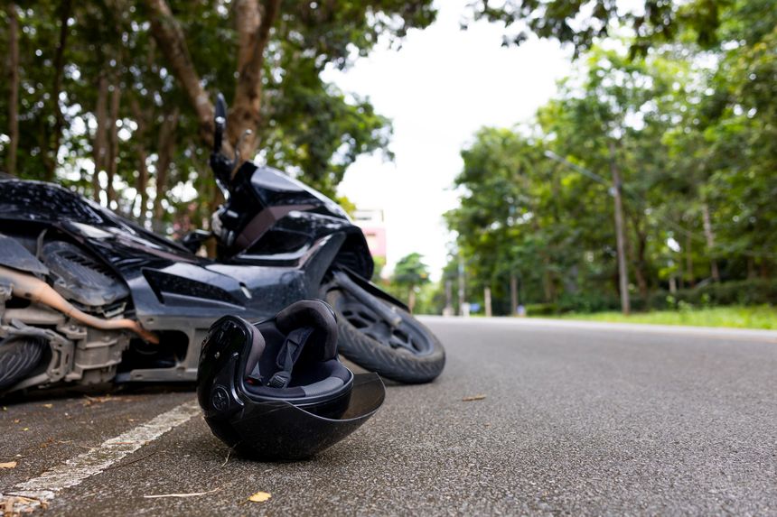 Motorcycle accident with helmet on road and safety reminder Save Life message, concept of road safety and awareness