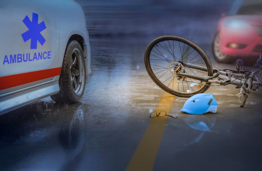 Accident car crash with bicycle on road ,rainy day at night time.
