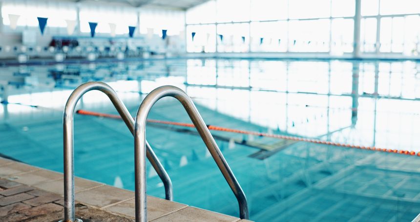 Swimming pool, handrail and sports facility with safety, event and wellness center for community. Empty, balance and water with bars for secure grip, accessibility and enter with exit or mobility