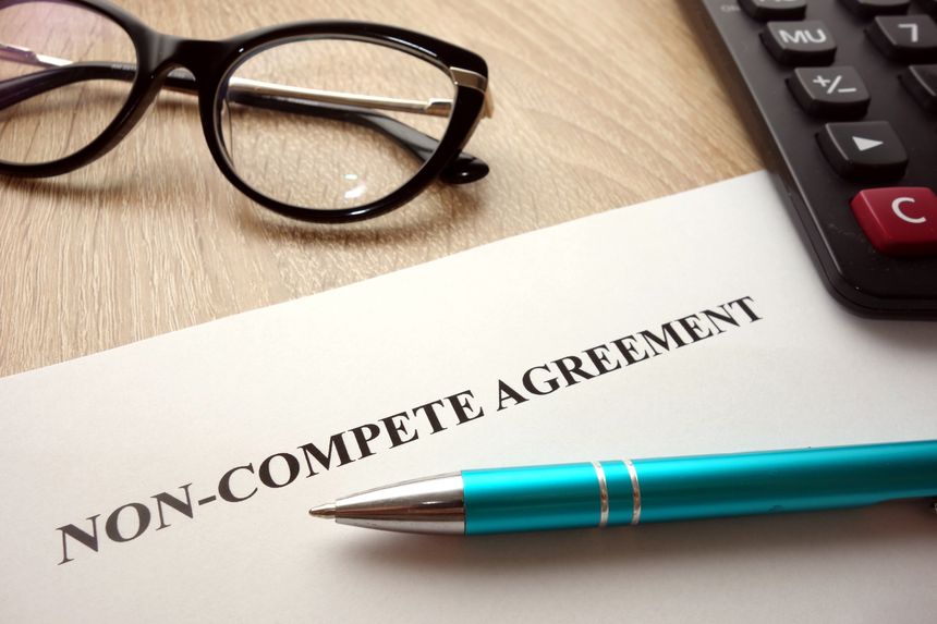 Non-compete agreement document for filling and signing on desk,
business competition concept