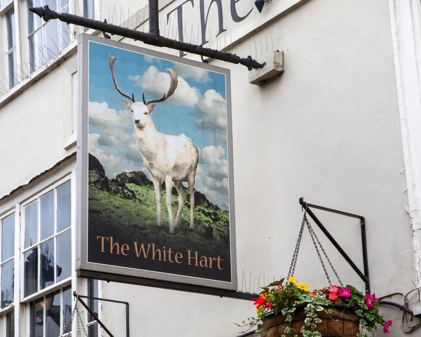Essex, UK - July 10th 2024: The traditional hanging sign on the exterior of The White Hart pub in the beautiful town of Coggeshall in Essex, UK.