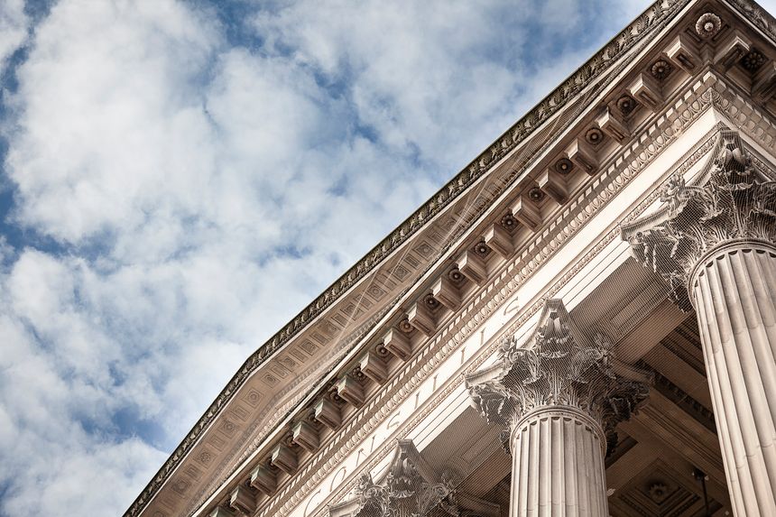 흐린 푸른 하늘과 기둥 건물크라운 코트 건물의 모래 돌 기둥