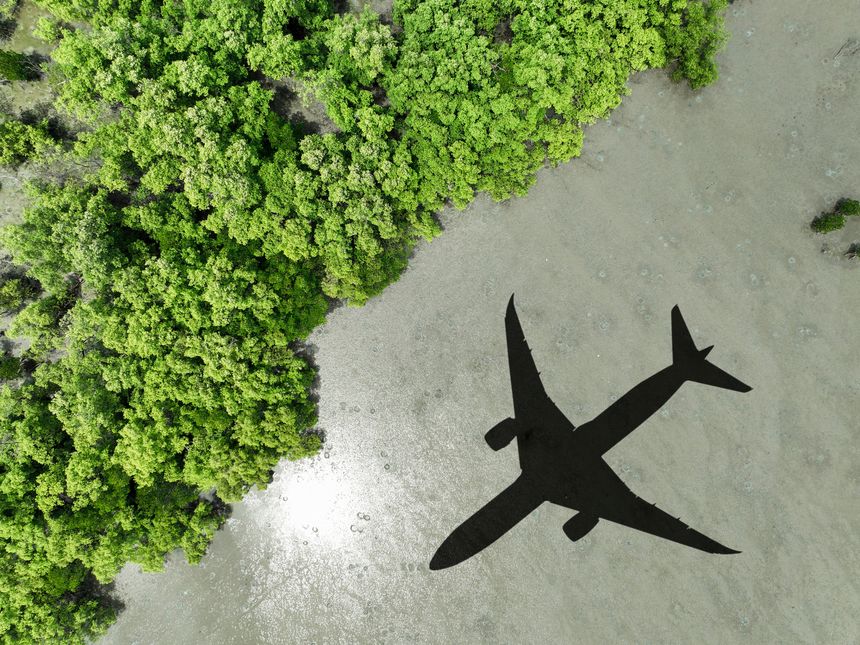 Shadow airplane flying above mangrove forest. Sustainable fuel. Biofuel in aviation. Sustainable transportation and eco-friendly flight with biofuel use. Aviation sustainability. Mangroves capture CO2