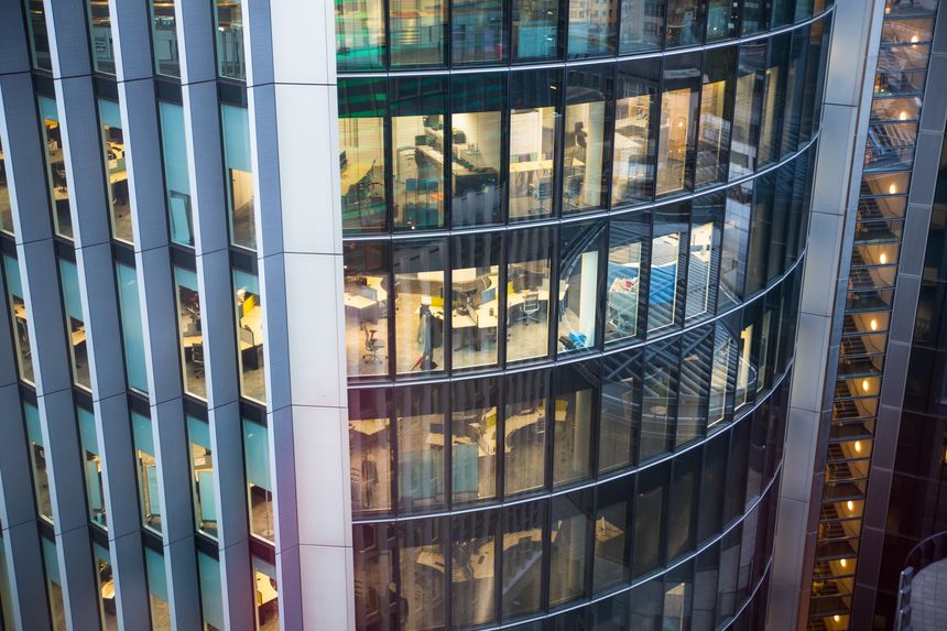 London, UK - 25 April, 2019: Office windows of City of london buildings at night