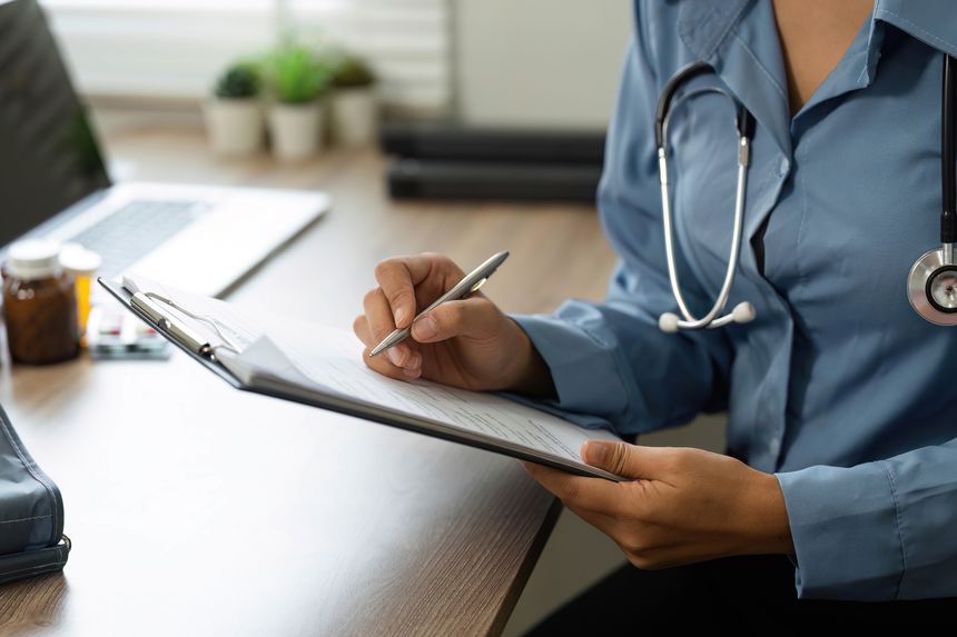 The nurse meticulously records notes, ensuring accurate documentation of the patient's health information for effective care.