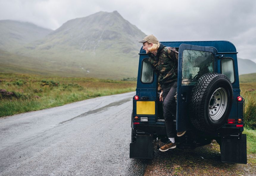 Man getting out of the cars back door