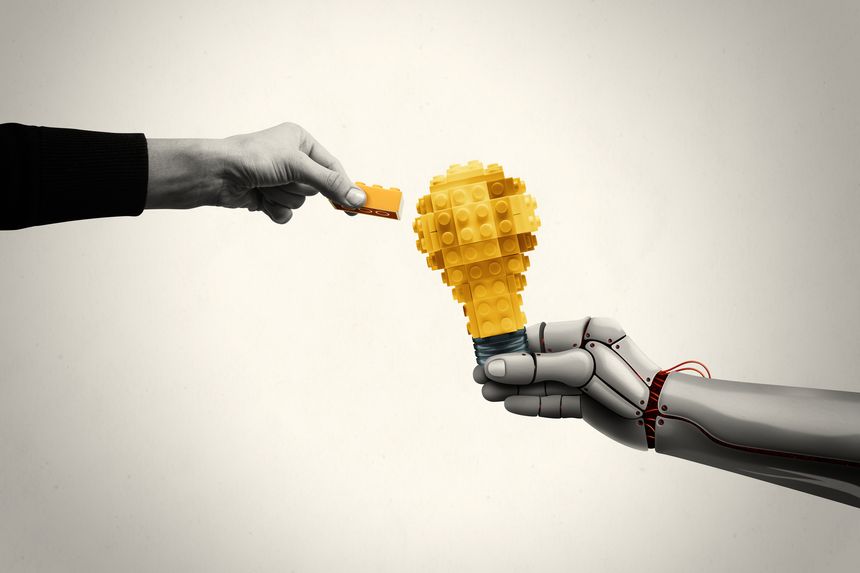 A robotic hand extends a light bulb to a person.