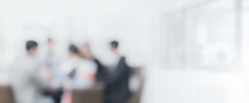Blurred office interior space with businessman and businesswoman meeting background with copy space.