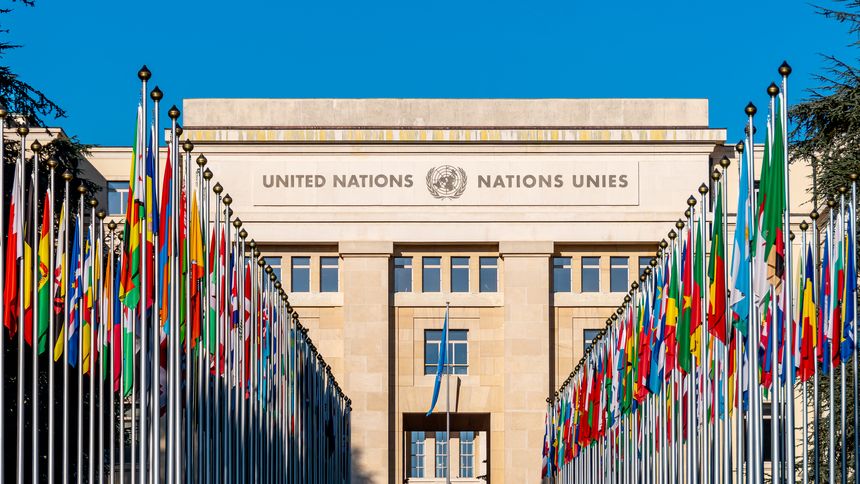 Geneva, Switzerland - November 16, 2024: Alley of Flags leading to the Palais des Nations, a complex of buildings housing the United Nations Office in Geneva, European headquarters of the UN