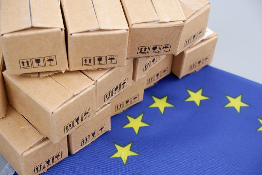 EU export concept. European Union flag and many carton boxes.