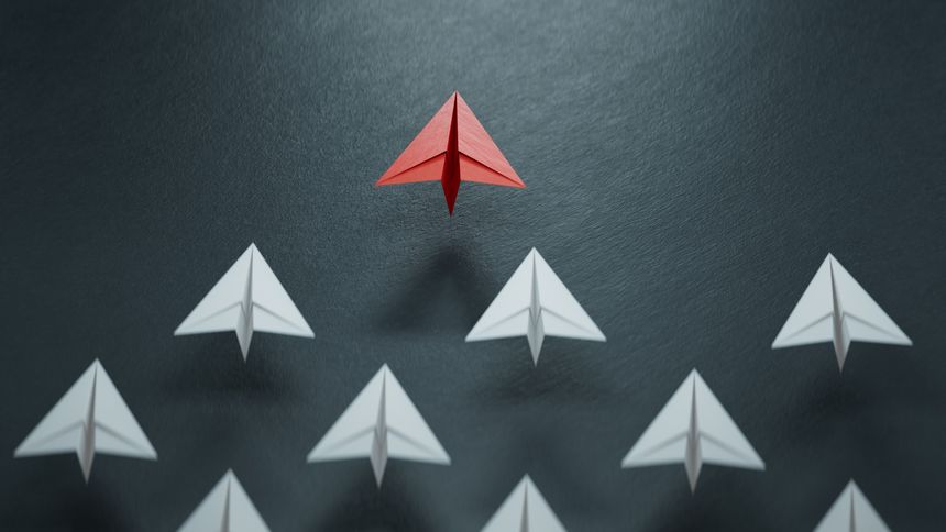 Different business concept.new ideas. paper art style.Leaderplane concept with red paper plane leading among white planes.3D rendering on black background.