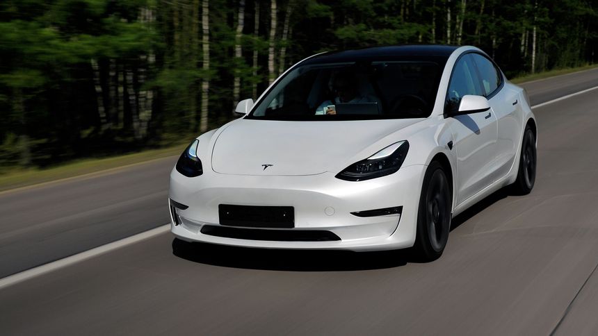 Minsk, Belarus - April 15, 2021: Tesla Model 3 Performance 2021 MY drives on a highway. It has dual-motor all-wheel drive, total output is 451 hp. Model 3 is the best-selling plug-in electric vehicle.