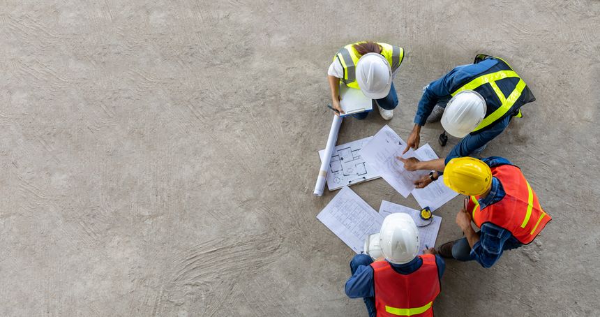 Top view of engineer, architect, contractor and foreman meeting at the construction building site with floor plan for real estate development project industry and housing timeline usage