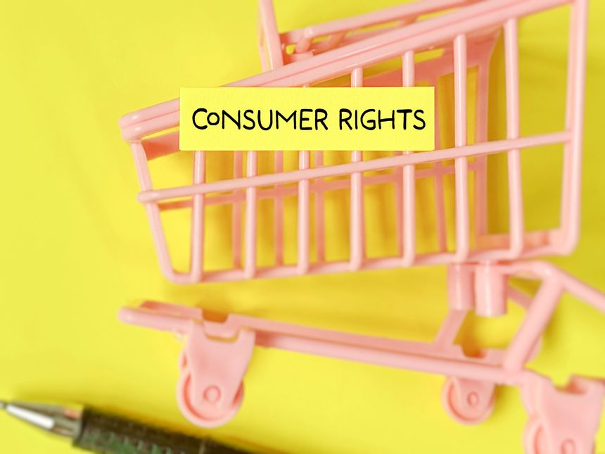 Consumer rights text written on adhesive note paper background. Stock photo.