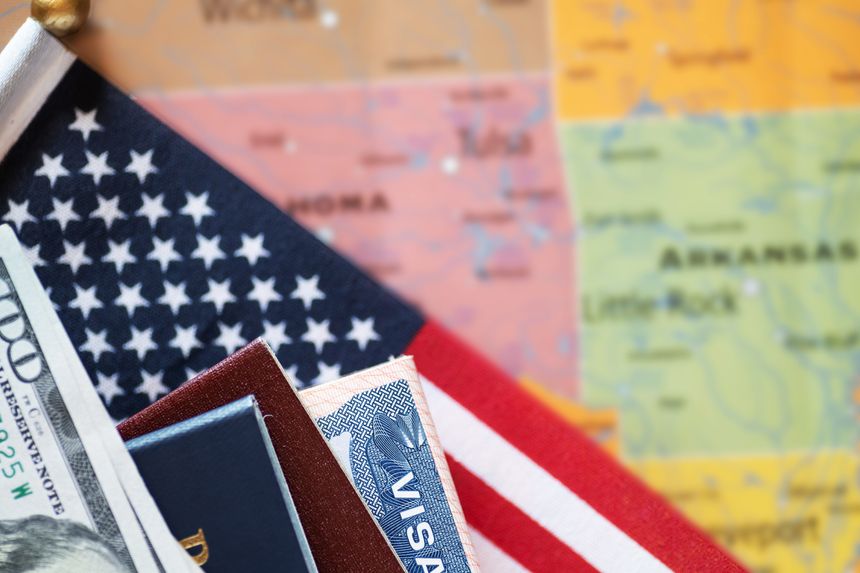 Visa with flag and US passport against a map of America.