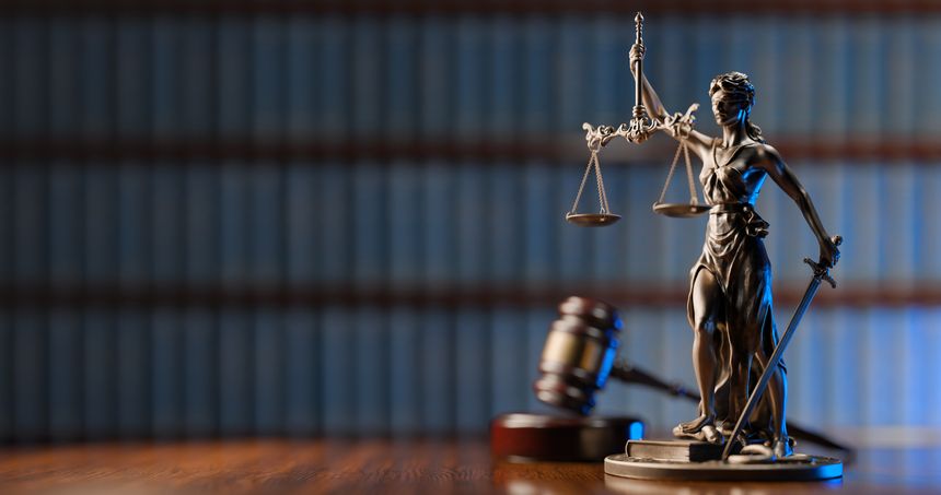 Legal Concept: Themis is the goddess of justice and the judge's gavel hammer as a symbol of law and order on the background of books.