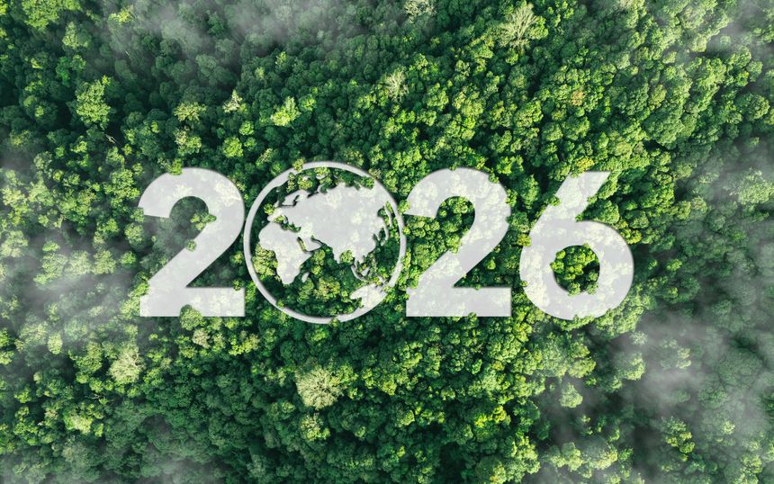 Aerial view of green forest with 2026 and Earth icon for environmental awareness, sustainability goals, and climate change action, happy new year and environment day, carbon reduction to net zero.
