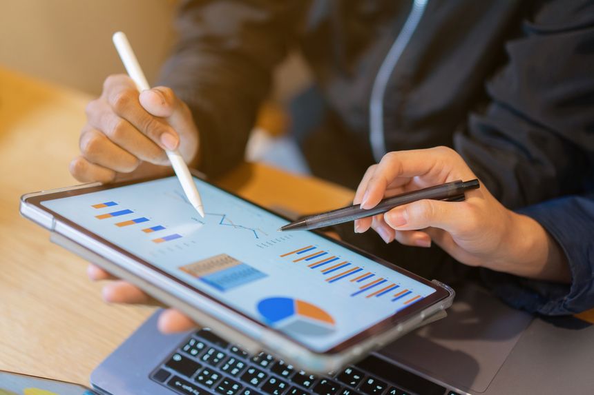 close up group of investor businesswoman hand point on tablet pad display for ask or consult about report  statistic with manager businessman in meeting room for kpi performance and strategy planning concept