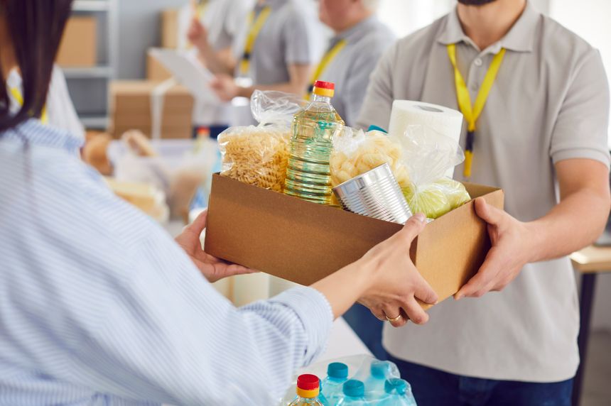 Food box giving to help, caring volunteer group working in charitable food foundation, make donation to needy, charity, separating donations stuff, food bank stocks, basic need provisions, free meal